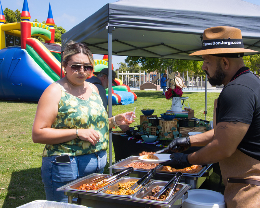 Guests enjoying tacos together at a large corporate taco festival