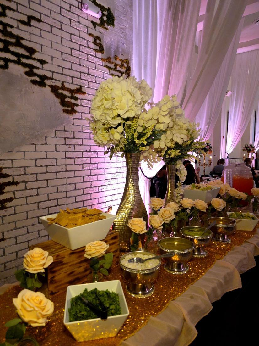 Ivory and gold appetizer station with tortilla chips and guacamole