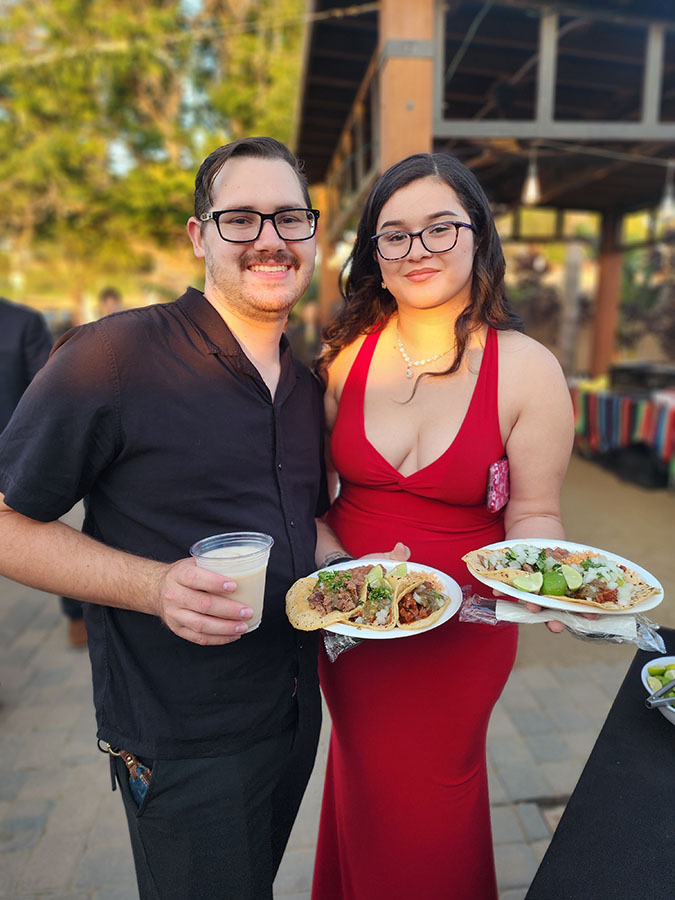 Quinceañera in a red ballgown at her outdoor celebration