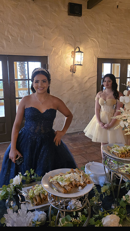 Quinceañera in a lavender gown serving herself from the Tacos Don Jorge taco buffet