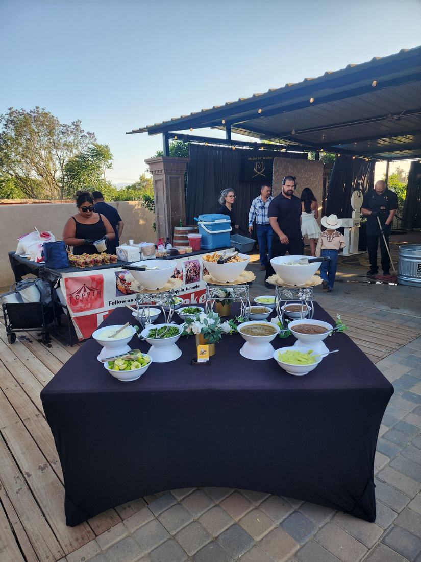 Salsa and toppings bar set up at an outdoor quinceañera