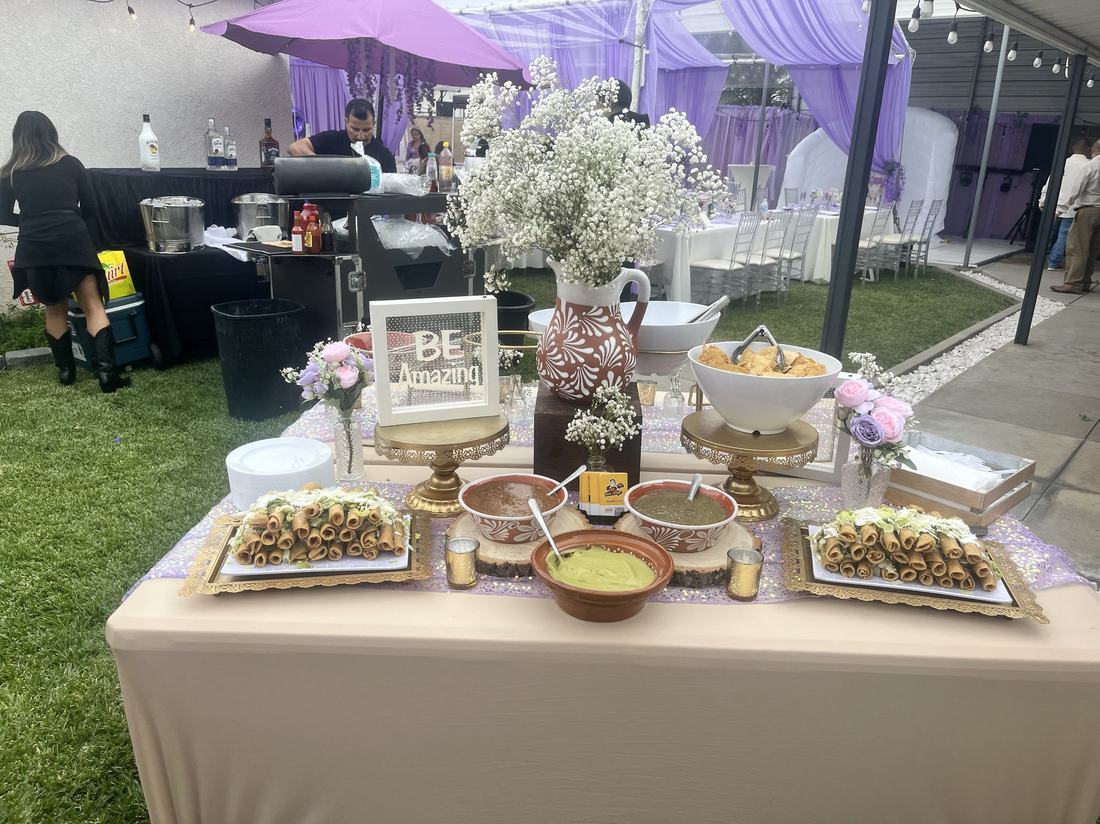 Taco station styled in a lavender and purple quinceañera color palette