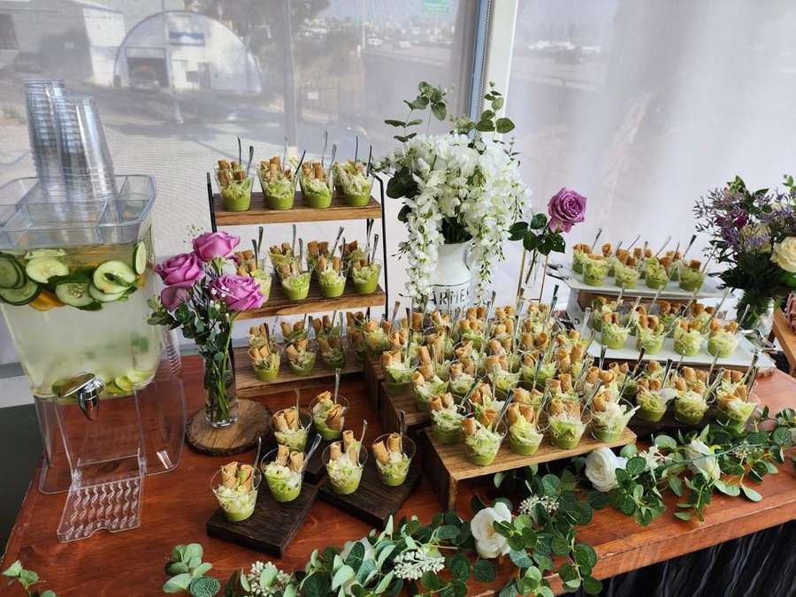 Individual appetizer cups display at a wedding cocktail hour