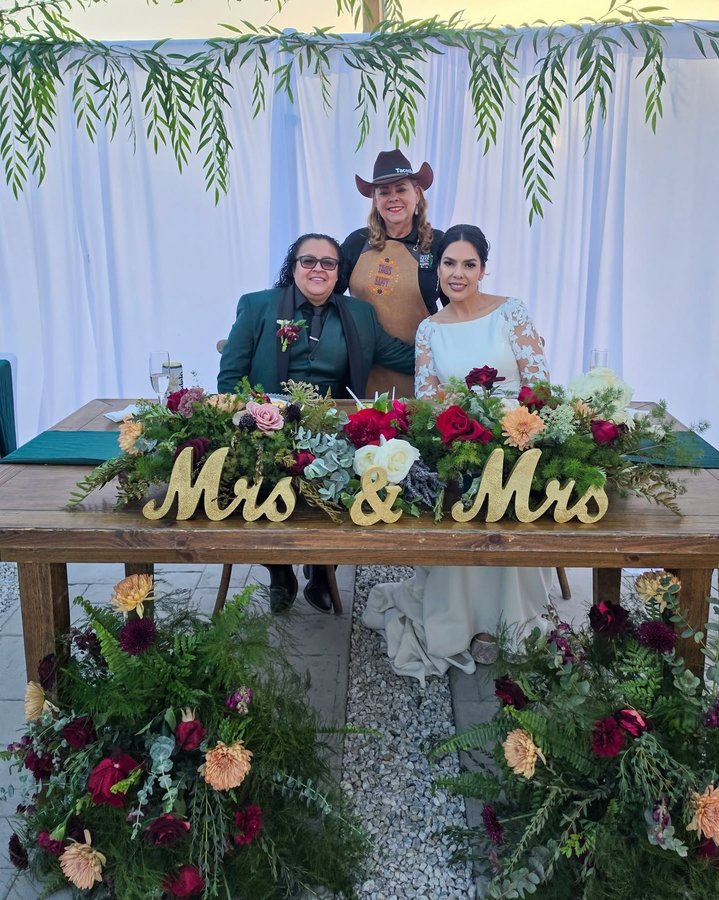 Lupita with two brides at their Mrs and Mrs wedding table