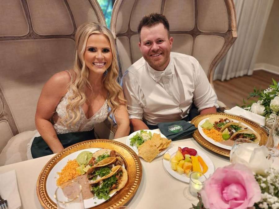 Wedding reception table with taco plates on gold chargers