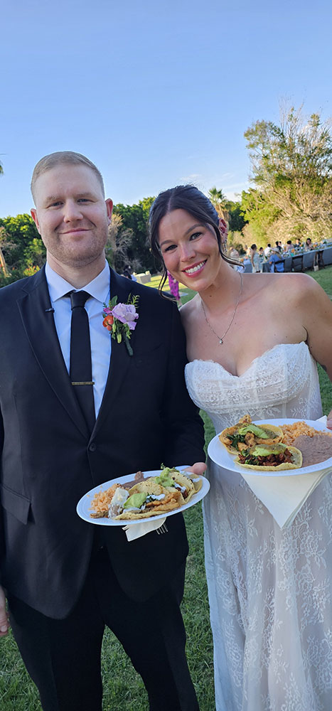 Newlywed couple enjoying tacos at their Tacos Don Jorge wedding reception