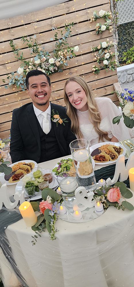 Groom and bride with Tacos Don Jorge staff at their wedding