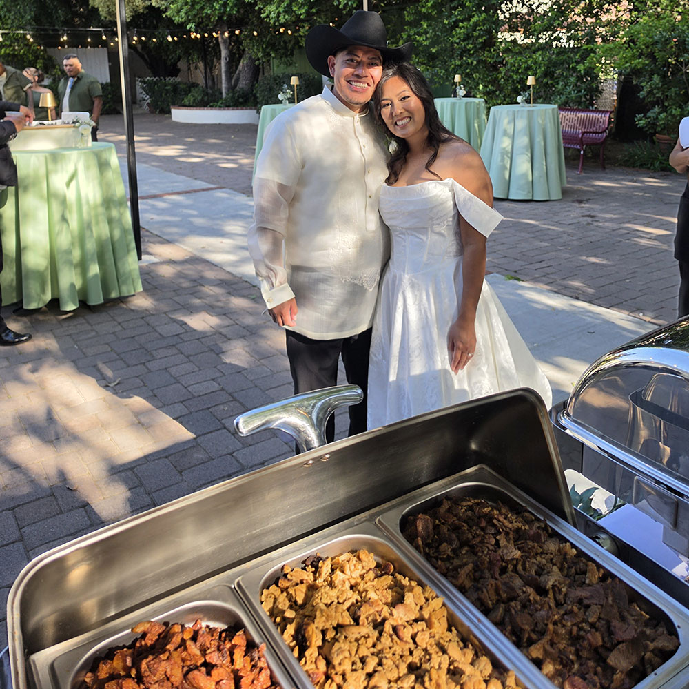 Couple enjoying a seated taco dinner at their wedding reception
