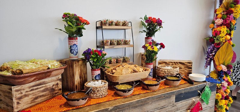 Appetizer and salsa station with taquitos, chips, and fresh guacamole