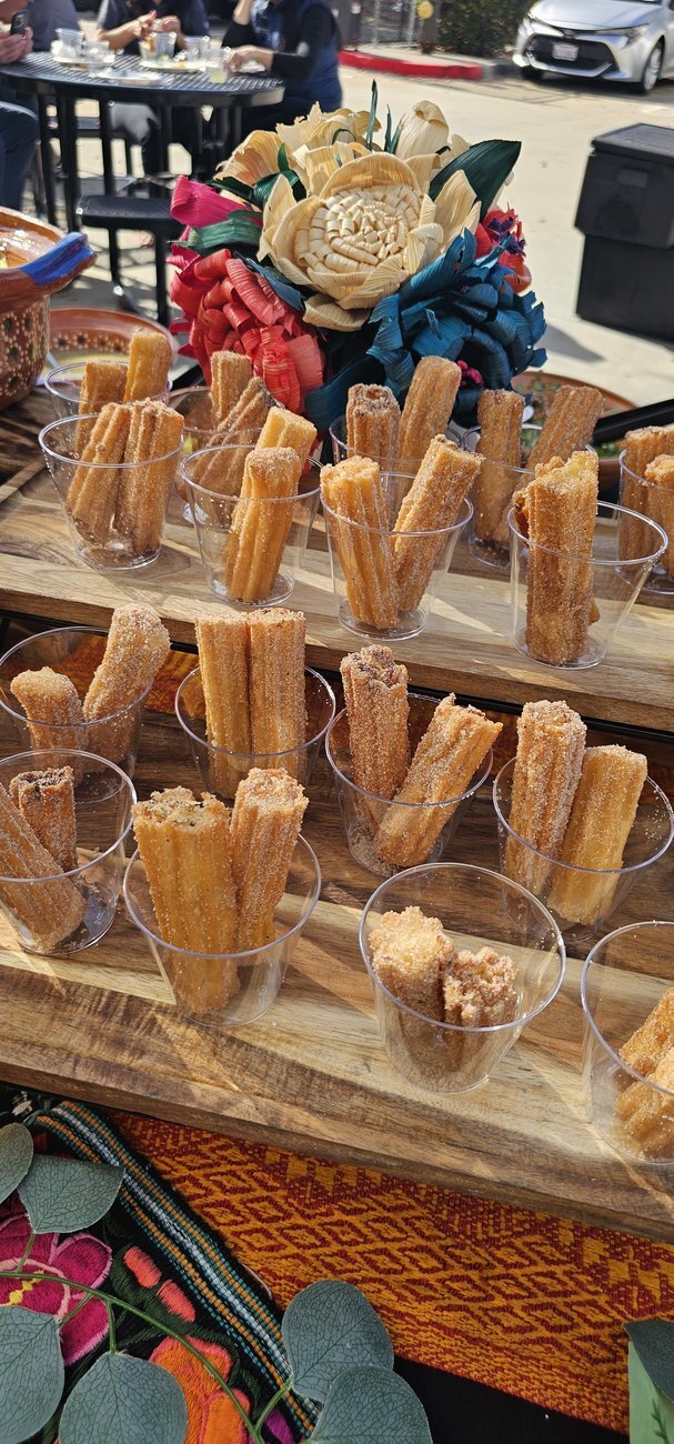 Individual churro cups served at a Taco Festival dessert station