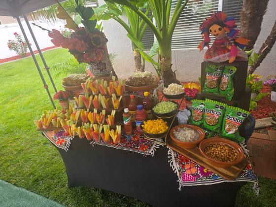 Fresh fruit and snack table at a Taco Festival backyard party